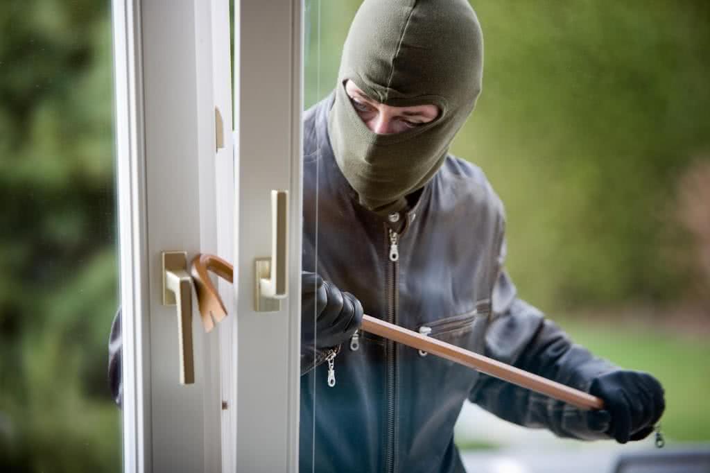 Burglar breaking into house