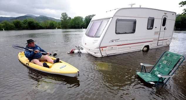 image of man in kayak after caravan park flooded
