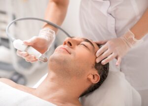 Senior man enjoying a laser facial beauty treatment